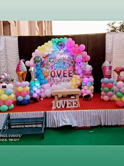 A wider view of the Candy Land stage setup, including donut and ice cream props made from balloons.
