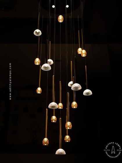 This view from below emphasizes the cascading arrangement of the multi-pendant chandelier, a design that adds depth and visual interest to any space.