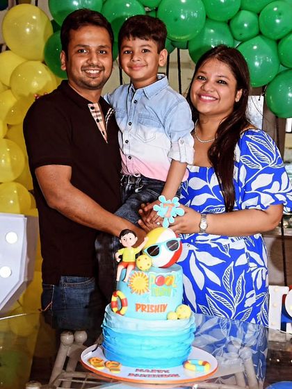 The happy family celebrating Prishiv's 7th birthday with his custom pool party cake.