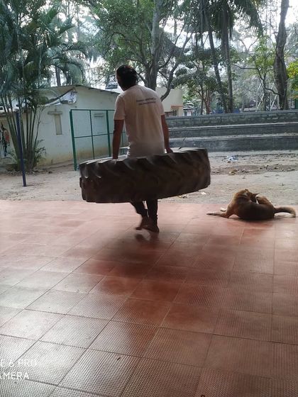 A student carries the tire across the training area. This drill is about persistence and will.