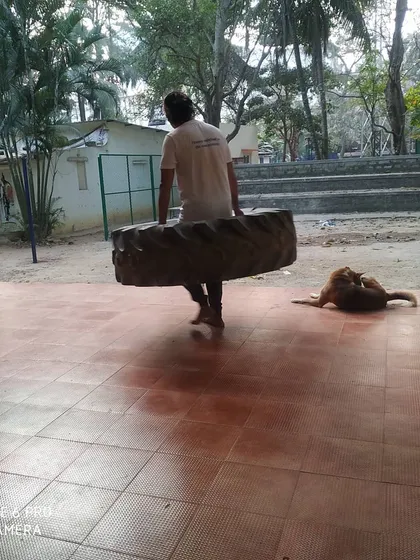 A student carries the tire across the training area. This drill is about persistence and will.
