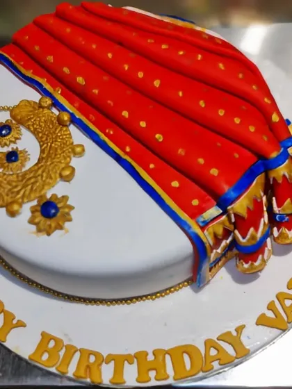A culturally rich and beautifully detailed cake celebrating Indian tradition. This design features a stunningly realistic fondant saree and intricate gold jewelry, making it a perfect and personalized centerpiece for a special birthday or celebration.