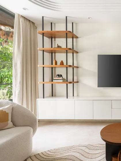 The open shelving unit is perfect for displaying books and curated decor, allowing the family's personality to shine through in a clean, organized way.