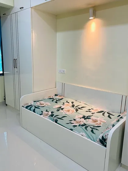 A closer look at the cozy daybed, perfect for reading or lounging. The spotlight above makes it a comfortable nook.