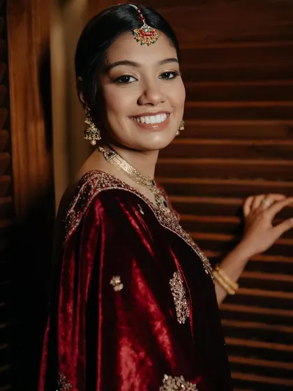 Fatema knew she wanted a classic, regal look. We used deep maroon and gold tones to complement her velvet lehenga, creating a look that was pure royalty. ❤️