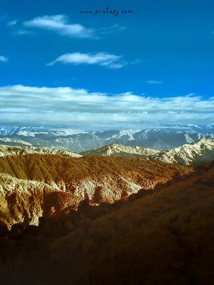 The mountains of Singalila National Park in infrared. The landscape is transformed into a palette of browns, yellows, and intense blues, looking more like a painting than a photograph.