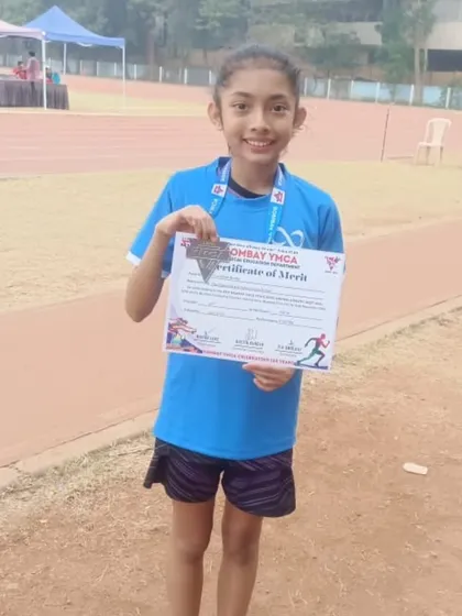 This young champion proudly displays her certificate of merit after a strong race.