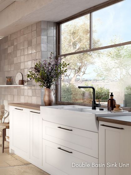 The double basin sink is a practical and stylish feature in this country-style kitchen, perfect for a busy family home.