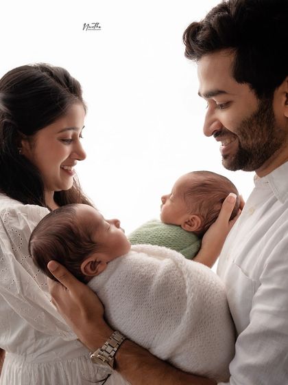 A father's joy as he holds his two newborn twins. A truly special moment.
