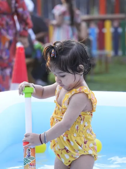 Even our littlest guests can join the water fun. A toddler safely plays with a water toy in the shallow end of our inflatable splash pool.