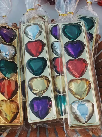 These jewel-heart chocolates are one of my favorite things to make. Each one is handmade and wrapped in colorful foil, making them a beautiful and delicious gift for someone special. They are perfect for custom chocolate gift boxes.