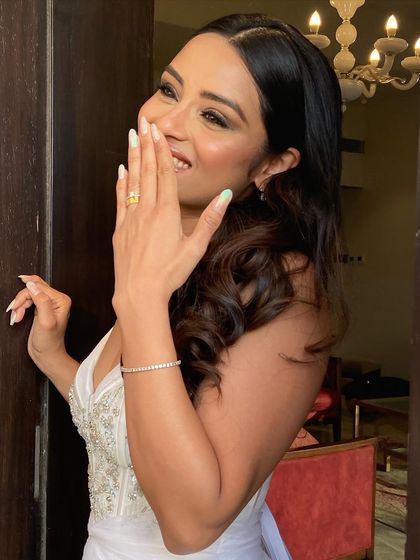 A candid moment of joy, with the bride's beautiful wavy hair on full display.