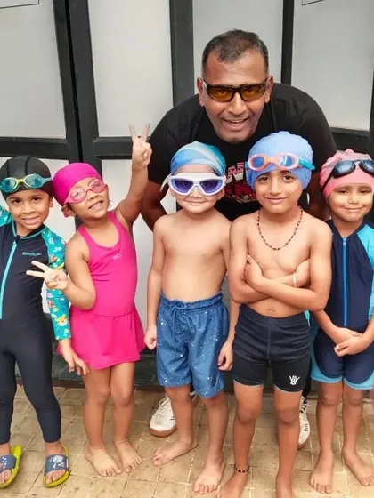 TRAIN THEM YOUNG AND LET THEM DREAM. Posing with my group of young swimmers. My goal is to instill a love for the water at an early age, giving them the confidence and skills to dream big.