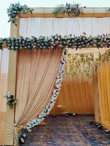 A closer look at the floral details on the wedding entrance. I use a mix of real and artificial flowers to create a lush, full look along the top and sides of the entryway.