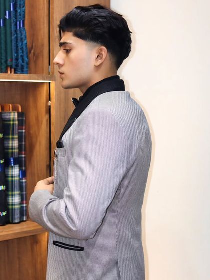 The side profile of this pinstripe double breasted suit highlights the clean lines and the way it's tailored to the client's body.