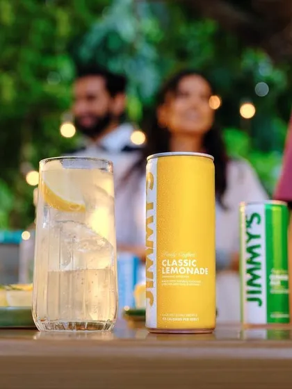 Another moment from the Jimmy's Cocktail party scene. The focus on the can and the prepared drink in the foreground, with the social interaction blurred in the back, perfectly balances product and lifestyle.