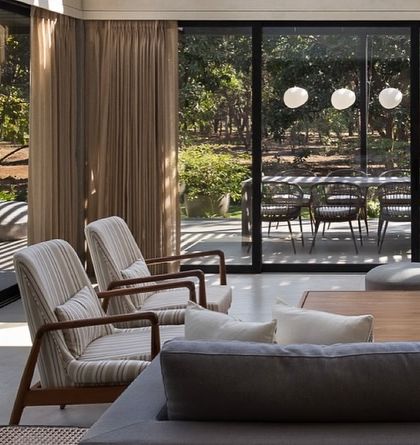 A view from the living room of the Mango Orchard House out to the expansive garden. The seamless connection encourages an indoor-outdoor lifestyle.