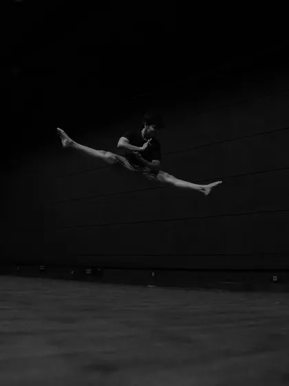 A moment of flight. This artistic shot captures a split jump, showcasing the athleticism and flexibility that is part of my dance practice. It's the chaos and energy of dance frozen in a single frame.