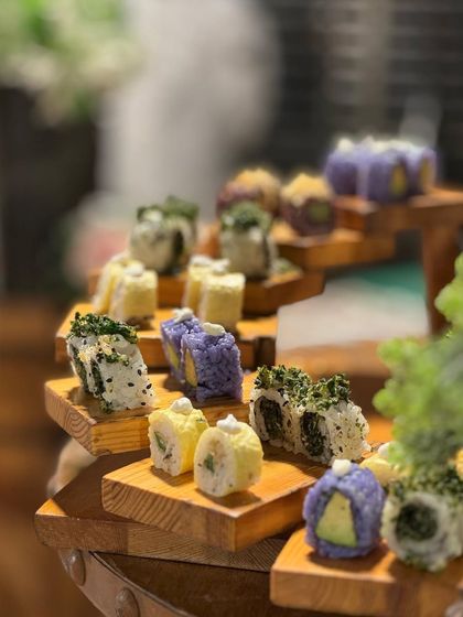 A beautiful tiered display of our assorted sushi rolls. The presentation is designed to be a centerpiece, inviting guests to explore the different varieties.