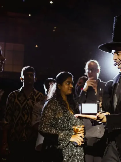Presenting an illusion on a digital tablet during the Jo Malone show. I often incorporate modern technology into my acts to create fresh and surprising effects that resonate with today's audiences.