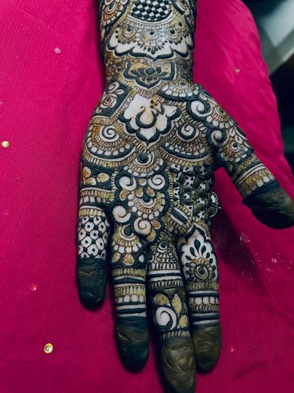 A close-up of the palm, showing the beautiful mix of bold, dark patterns and delicate, light shading.