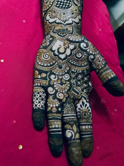 A close-up of the palm, showing the beautiful mix of bold, dark patterns and delicate, light shading.
