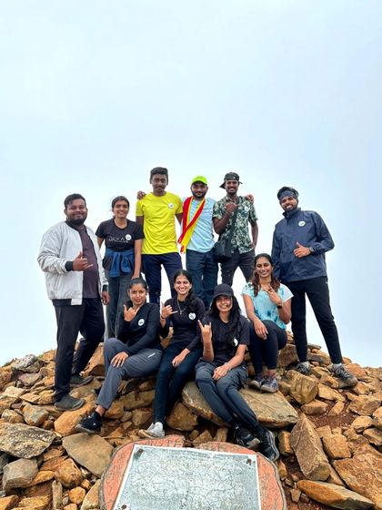 The group at the very top of Kudremukha peak, sitting on the pile of rocks that marks the summit.