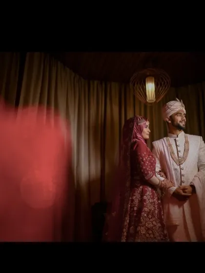 A cinematic portrait of the bride and groom standing together after their Nikkah. The warm lighting and dramatic composition give this moment a timeless, storybook quality.