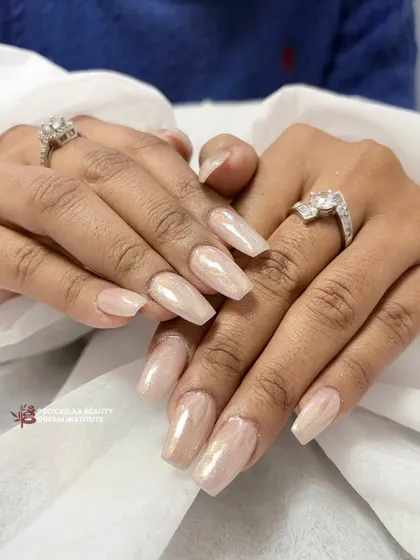 A beautiful and simple set of long coffin nails with a pearlescent, champagne-colored polish. This look is all about that clean, high-shine finish.
