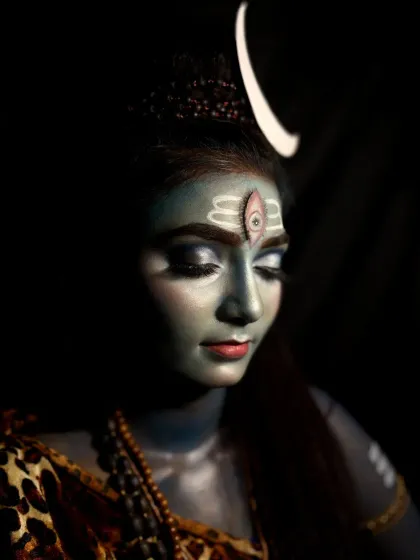 This angle shows the makeup details from the side, including the arm markings and the way the crescent moon headpiece is integrated into the look.