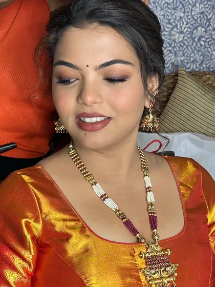 A close-up on the soft, smudged eye makeup and nude pink lips.