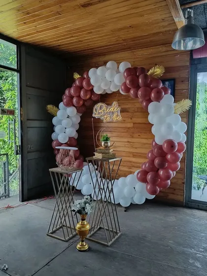 This full circular balloon arch is one of our most requested designs for bachelorette parties. The rich burgundy and white balloons, paired with a custom 'Bride to be' neon sign, create a sophisticated and celebratory focal point, perfect for any indoor or covered venue.