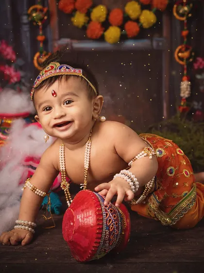 Celebrating culture and childhood joy with a themed Janmashtami photoshoot. This little one, dressed as Krishna, brings so much playful energy. I love creating these vibrant, imaginative setups that honor our traditions and capture your child's delightful spirit.