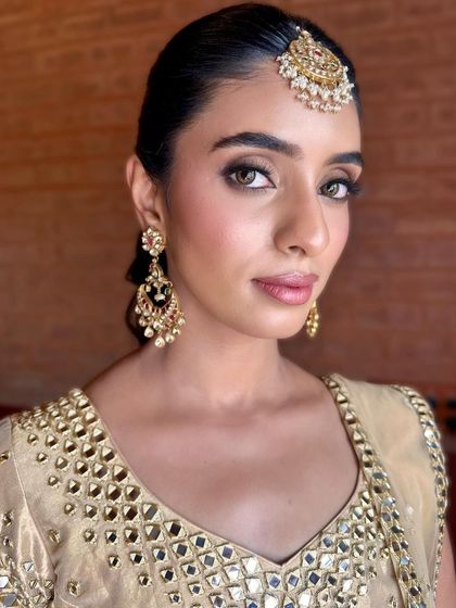 A direct portrait showing the beautiful symmetry of the makeup. The defined brows and clean eye makeup frame her face perfectly.