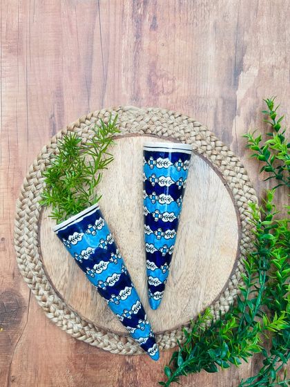 Another look at our hand-painted ceramic conical wall planters. The blue and white floral design is a classic and elegant choice for your indoor or outdoor garden.