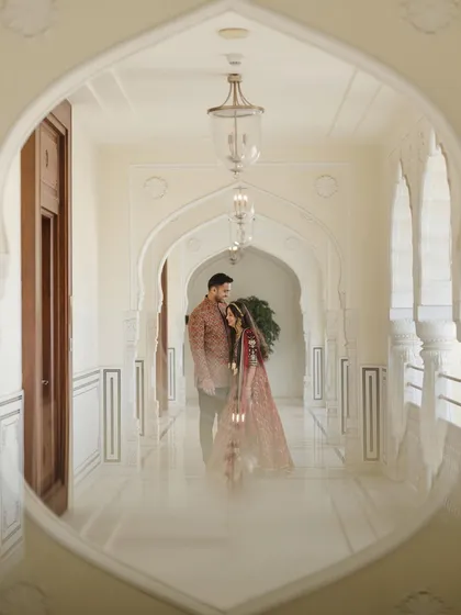 A beautifully framed shot through an archway at a Jaipur heritage hotel. We use architectural elements to create depth and a sense of intimacy in our pre-wedding photography.