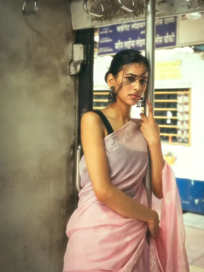 Standing at the train door, a classic Mumbai experience. This portrait captures the wind and the feeling of the city rushing by.