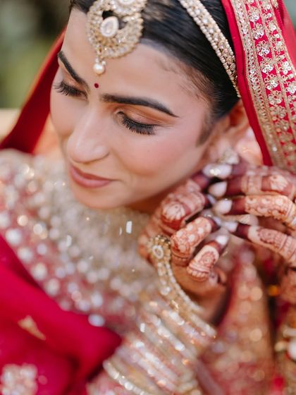 A close-up of our graceful bride, Varsha. Her look is all about a soft, dewy canvas, with poetic eyes and a soul that glows brighter than her jewels.