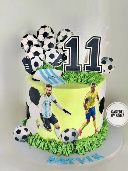 A football fan's dream cake, featuring star players Messi and Ronaldo. The cake is decorated with multiple footballs and edible grass for a stadium feel.