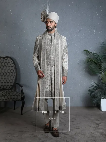 A sherwani that is a reflection of culture, grace, and legacy. The ivory base whispers purity, while antique zardauzi embroidery and sparkling beads celebrate tradition.