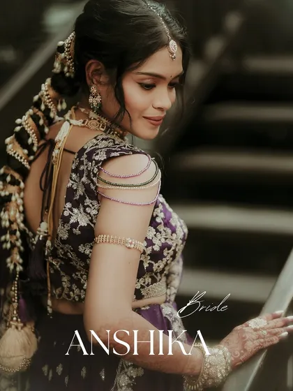 An elegant portrait highlighting the bride's stunning attire and hairstyle. The focus on her embroidered blouse and traditional braided hair makes for a beautiful and detailed bridal shot.