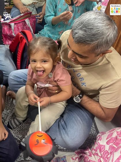 A father helps his daughter with a craft during our Ramkatha event. It's wonderful to see parents getting involved and sharing these creative moments with their children.