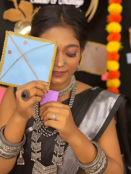A playful shot with a kite prop, perfectly capturing the spirit of the Makar Sankranti festival.