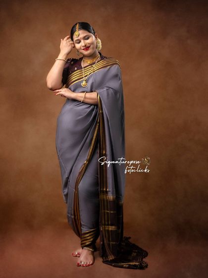 A standing portrait in a grey saree, highlighting the elegant drape and the mother's serene expression.
