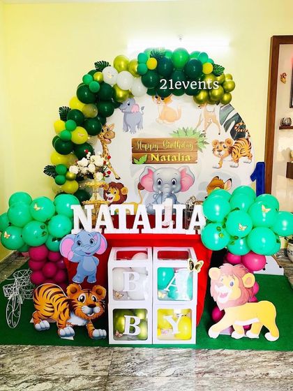 Another angle of the cartoon jungle theme, showing the full setup with character cutouts and balloon clusters.