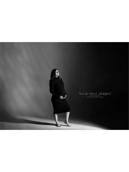 "You are best day ever." This wide-angle black and white studio shot captures the joy and beauty of pregnancy, with dramatic lighting creating a spotlight effect.