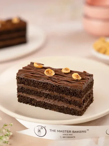 This decadent Chocolate Hazelnut pastry is the perfect way to satisfy your sweet tooth. It features multiple layers of rich chocolate sponge and a smooth, nutty hazelnut cream.