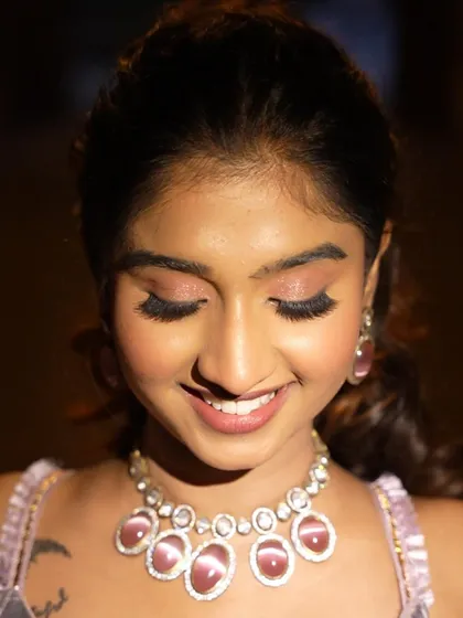 Eyes closed, you can see the soft blend of pink and neutral eyeshadows. It's a subtle but beautiful detail.