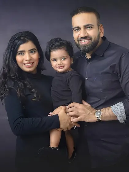 This stylish family looks so elegant in their coordinated outfits for a studio portrait session. A timeless way to capture your family at this stage.