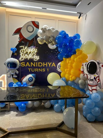 Another angle of the home-based space theme, showing the arrangement of balloons and props around a dining table.